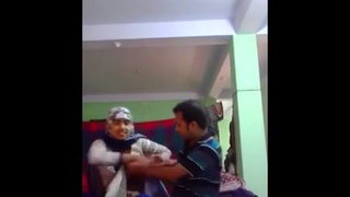 A veiled Pakistani woman performs a vigorous oral sex act on a man