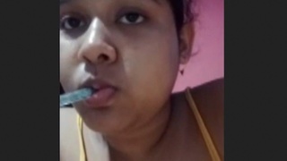 An Indian woman seductively pleases her partner in a sensual recording