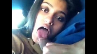 An Indian girlfriend performs oral sex on her boyfriend in a vehicle