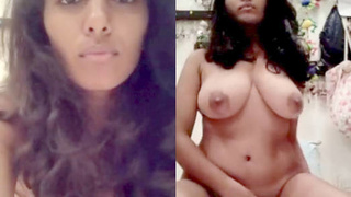 A young woman from India with large breasts reveals them
