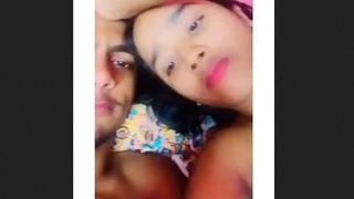 A charming and isolated young woman pleases her partner with an enthusiastic oral experience, showcasing her ample bosom.