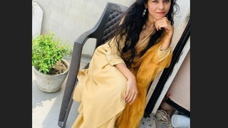 A stunning dark-haired woman and her partner savor the joys of intimacy