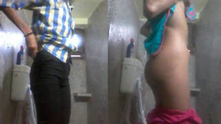 South Asian woman switches outfits in restroom