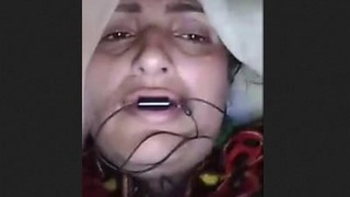 Elderly wife demonstrating, labeled as bhabi