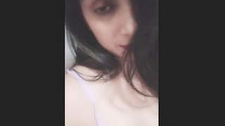 A stunning woman flaunts her large breasts and tight vagina