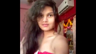 A seductive woman undresses and tantalizes in her private room