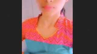 A lovely Indian teenage girl reveals her breasts and vagina