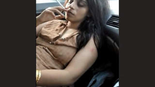 Indian escort Bushra undresses in a car in this heated video