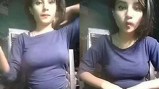 A stunning Indian girl flaunts her curves in a form-fitting dress and poses seductively in a call