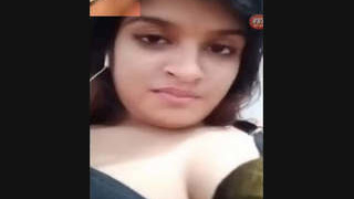A seductive Indian woman of South Asian descent reveals her pale breasts and intimate area