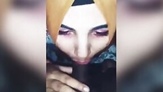 Attractive girl in a hijab pleases her boyfriend with a blowjob.