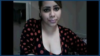 An attractive Indian college student proudly displays her large breasts