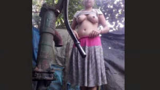 Attractive wife takes outdoor bath, displaying her body and self-pleasureing