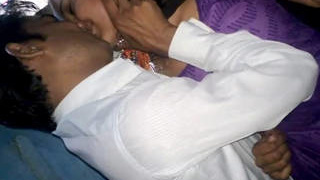 Indian pair passionately kissing in a purple salwar suit in a rural setting