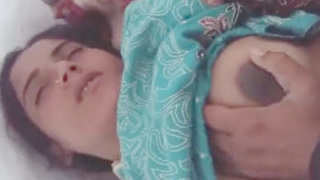 A Pakistani wife moans with pleasure as she masturbates with a large penis