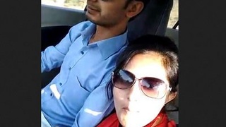 A couple engages in sexual activity recorded on their mobile phone while in a car